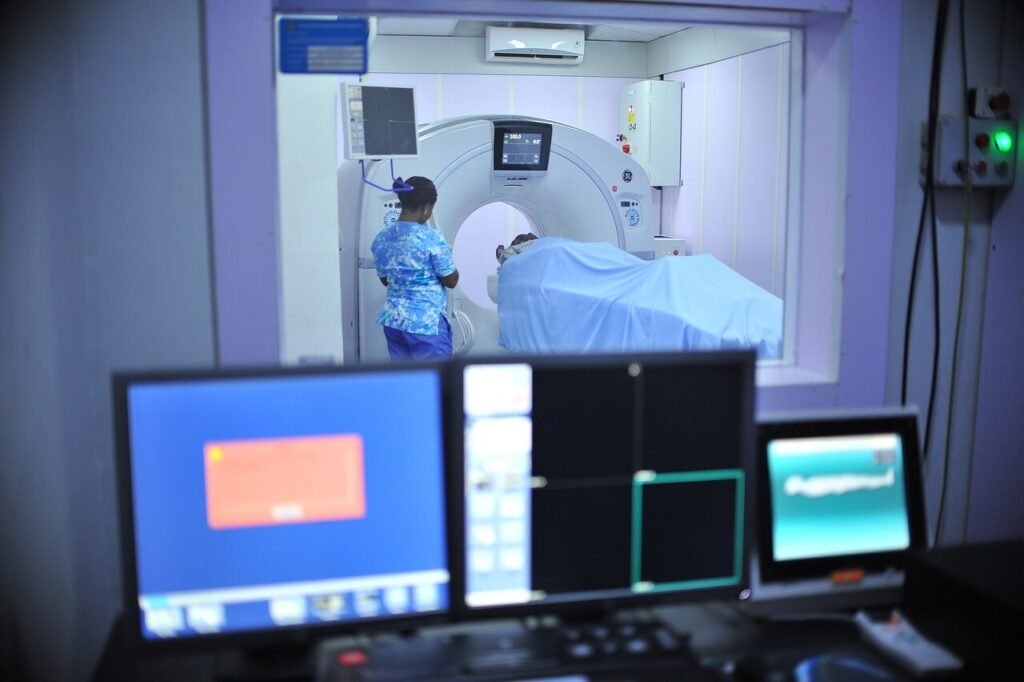 MRI scan room with magnetic resonance imaging machine and patient bed, showing a clean and modern diagnostic setup.